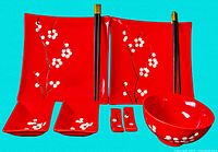 Photo of all items including plates, bowls, chopsticks, holders, and serving bowl showing design and colors
