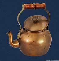Vintage copper teapot with rounded body, serpentine spout, wooden handle and knob, showing patina and wear marks on copper surface.