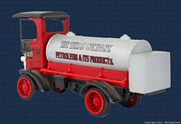 Front and left side view of vintage red and gray die-cast 1910 Mack Texaco tanker truck coin bank.