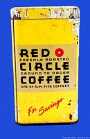 Front view of vintage Red Circle Coffee tin coin bank showing yellow color with black, gold, and red lettering and red circle logo. Shows wear and paint chipping.