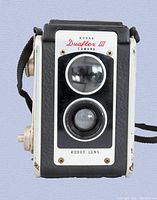 Front view of Kodak Duaflex III camera showing twin lenses and front plate with model name.