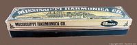 Side view of the original box showing 'MISSISSIPPI HARMONICA CO.', Regal logo, and vintage design.