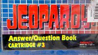 Close-up photo of sealed retail packaging showing the Jeopardy logo, 'Answer/Question Book CARTRIDGE #3,' and Tiger Electronics branding with model number.