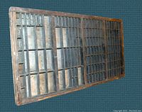 Front angled view of the wooden printer's letterpress tray drawer showing compartment divisions.