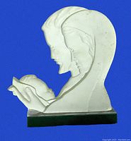 White hard plastic Holy Family statue with Jesus, Mary, and Joseph in profile on black base.