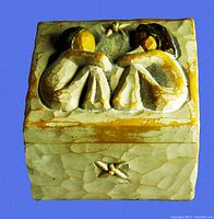 Front view of vintage Willow Tree Friendship Trinket Box showing carved figures on lid and flower detail on box front.