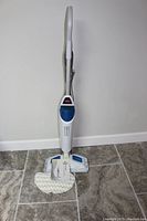 Full view of Bissell PowerFresh steam mop standing upright with one mop pad attached on floor.