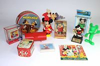 Wide view of the full collection showing all items including tins, figures, puzzle, and card.