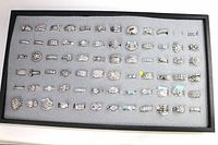 Top-down view of full tray showing all 72 rings on grey foam in black frame