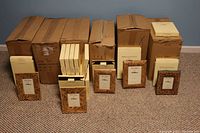 Several cardboard boxes containing multiple individual boxes of new floral patterned picture frames.