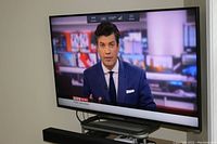 Television powered on displaying BBC News