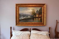 Full view of painting hung above a bed showing overall appearance and scale