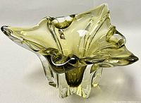 Front angled photo of a ruffled Sommerso freeform blown art glass bowl showing yellow-green inner color with clear outer glass layers.