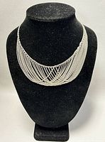 Full front view of the 17-inch Art Deco sterling silver necklace on a black display bust showing the intricate multiple overlapping chain design.