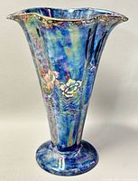 Front and side view of the blue lustre floral vase showing scalloped rim and iridescent glaze with floral detail.