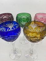 Front angled view of the five colored Bohemian cut to clear hock wine glasses showing each color and size.