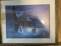 Framed winter scene print featuring a house, snowman, snow-covered trees, and a lit lantern, titled Once Upon a Winter's Night by Michael Humphries