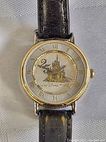 Full view of the Disney limited edition wind-up watch with leather strap and castle illustration on dial.