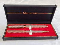 Original Maruman black box with red interior holding a fountain pen and mechanical pencil with silver textured barrels and gold-tone clip and trim.