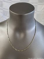 Front view of thick sterling silver chain necklace displayed on a mannequin bust, showing length and thickness.