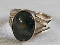 Front view of sterling silver ring showing green oval stone with black veins.