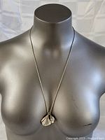 Front view of the necklace displayed on a mannequin showing the length and pendant size.