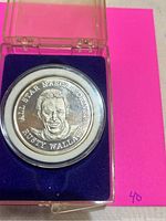 Front of the coin showing engraved face of Rusty Wallace with label.
