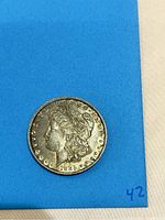 Obverse side of the 1885 Morgan Silver Dollar showing Lady Liberty portrait and date 1885.