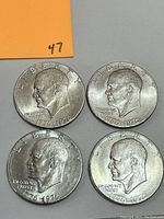 Obverse side of four Eisenhower Bicentennial coins showing profile of Eisenhower, dated 1776-1976 with LIBERTY inscription.
