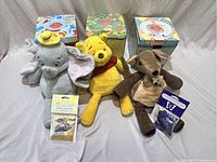 Front view showing three Disney plush warmers Dumbo, Winnie the Pooh, and kangaroo with joey, plus their Scentsy boxes and accessories.