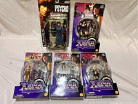 Photo of five action figures still in their original packaging including four Xena: Warrior Princess figures and one Psycho figure.