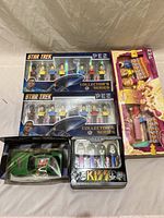 Lot image showing all items including two Star Trek Pez sets, KISS Pez set, Disney Pez pack, and green race car toy