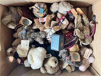 View of mixed Boyd's Bears plush and figurine collectibles in a box, showing some with knitwear and original tags.