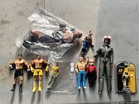 Full group of nine figures including boxers, pilot, and smaller figures in various outfits, some loose and some packaged.