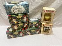 Boxes of Old World Christmas bulbs stacked with Holiday Greetings boxed ornaments included.