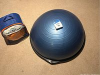 Blue exercise balance ball with measurement tag on top