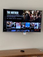 Wall-mounted LG TV powered on showing Netflix interface