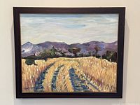 Framed acrylic painting depicting rain tracks through a cornfield with mountains in the background.