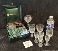 Full set with all waterford glasses and display box, alongside a water bottle for size reference