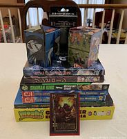 Stacked books and collectible cubes showing titles and character artwork