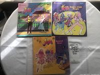 Three Jem books with colorful illustrated front covers featuring characters and titles.