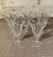 Front view showing 8 faceted crystal wine glasses arranged in two rows