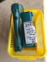 Top view of Makita cordless sander and flashlight with a yellow basket.