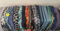 View of all 15 scarves arranged side by side showing color and pattern variety
