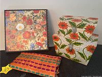 Photo of 12x13 inch floral artwork featuring poppies beside two painted wooden decorative boxes.
