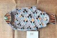 Top view of the fish-shaped ceramic platter showing the detailed multi-colored scale pattern and striped accents on head and tail.