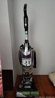 Front full view of the Bissell Pet Hair Eraser upright vacuum showing handle and dust canister