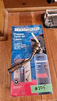 Original box of Mastercraft 7-piece propane torch kit with torch head attachment in front showing branding and kit details.