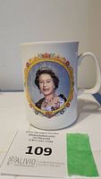 Front view of the ceramic mug showing a detailed color portrait of Queen Elizabeth II with decorative golden frame.