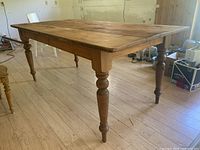 Front perspective showing solid pine top and turned legs